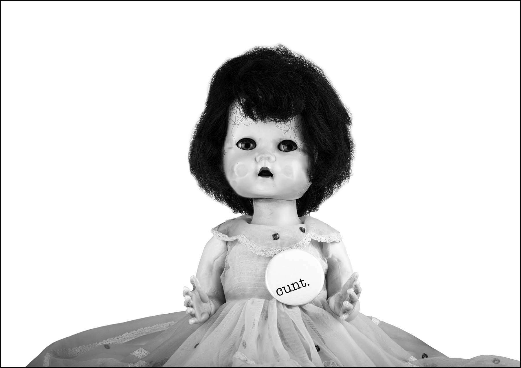 Doll wearing cunt badge