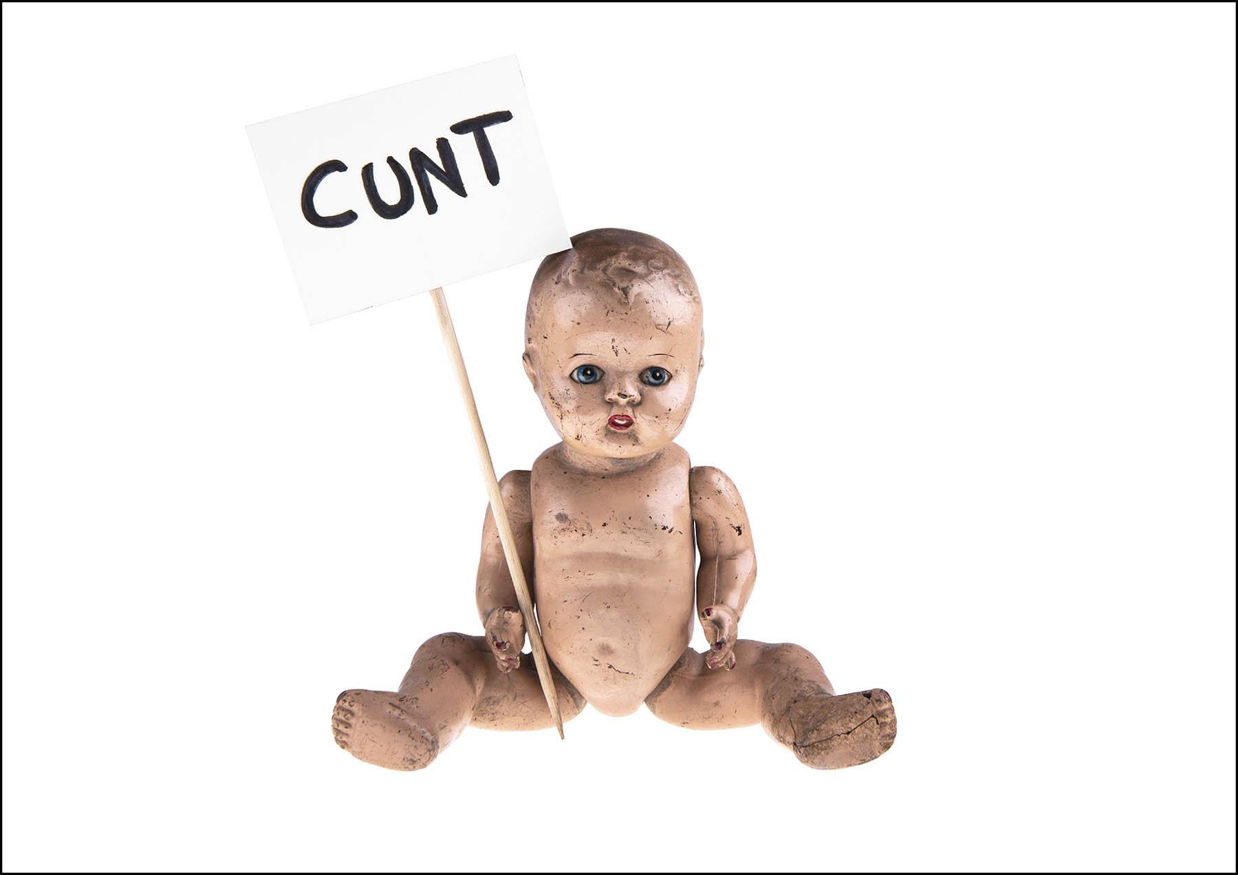 Doll with cunt placard